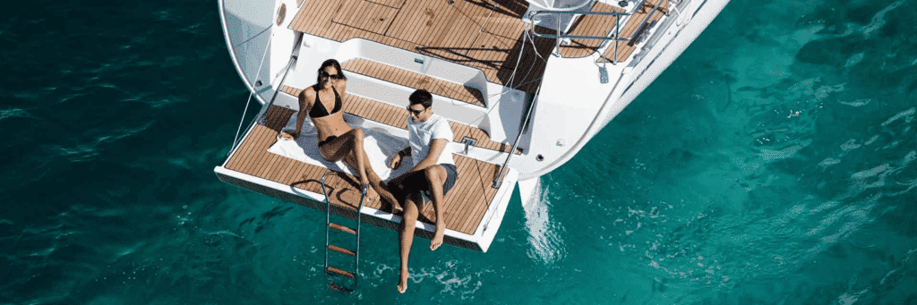 Couple relaxing on the stern of the sailboat