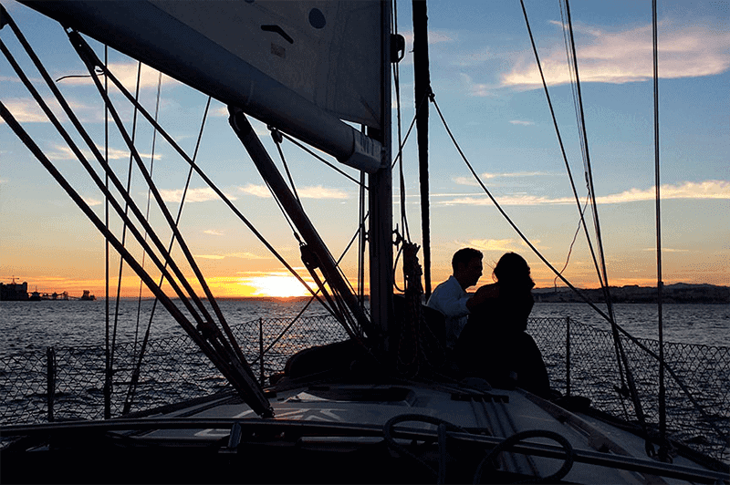 Couple on sailboat during sunset