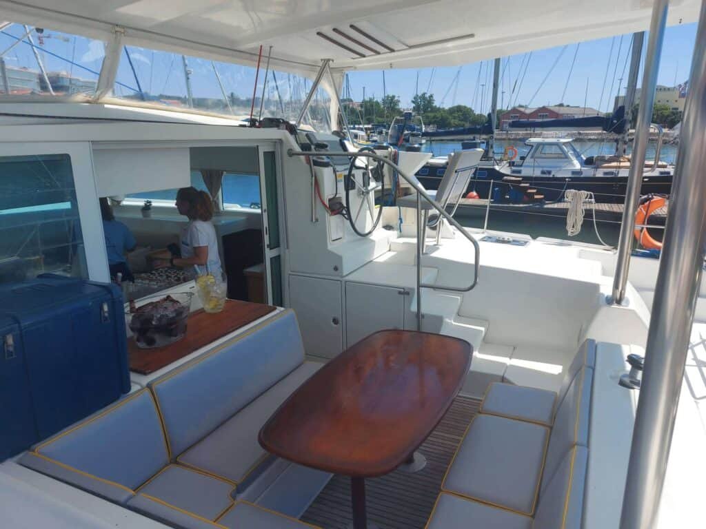 Area at the stern of the catamaran with table and sofas