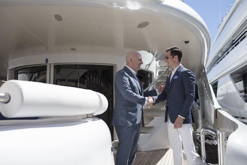 Two men shaking hands on a boat