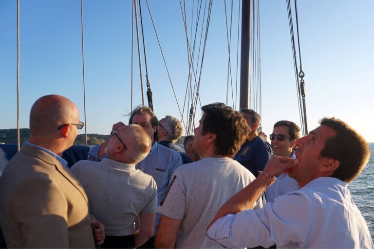 Team Building Events, men trying to understand how the boat's sails work