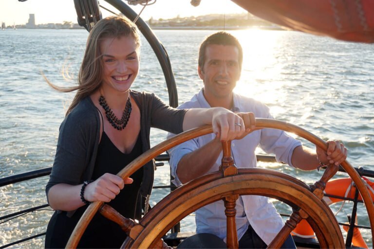 Team Building events, couple at the sailboat's helm