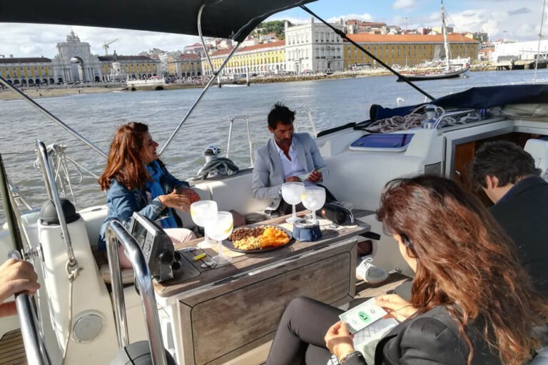 People on a sailboat viewing Commerce Square and St. George's Castle
