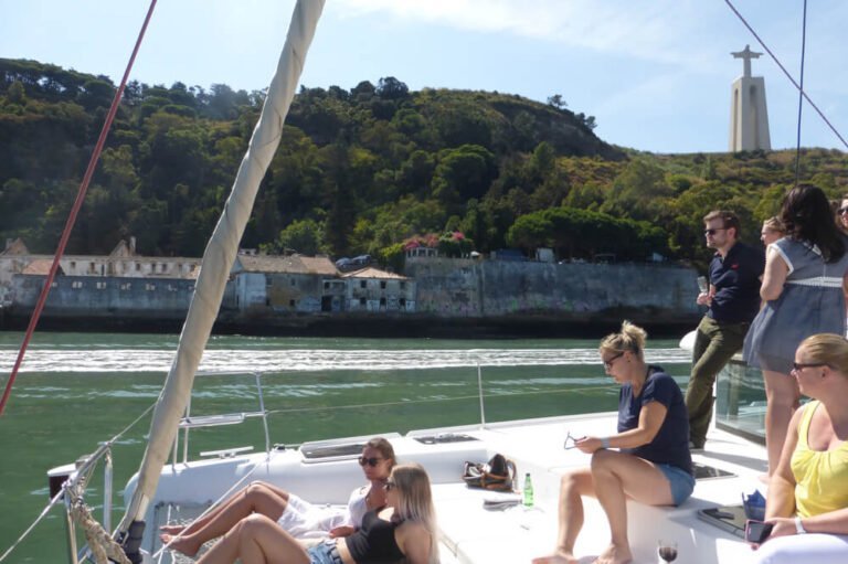 People enjoying a sunny day aboard a catamaran in Lisbon
