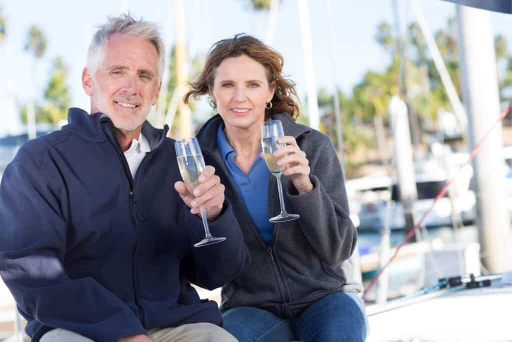 Couple toasting aboard a sailboat
