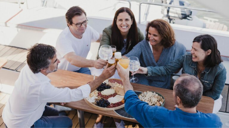 Friends celebrating life with joy, drinks, and Portuguese tapas
