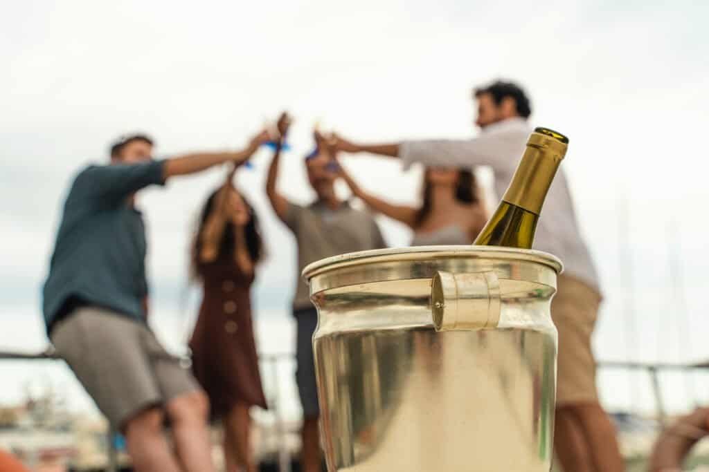 Los amigos brindan con vino en la cubierta del barco