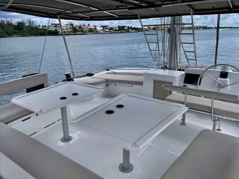Flybridge with bimini top, tables, and cushioned sofas