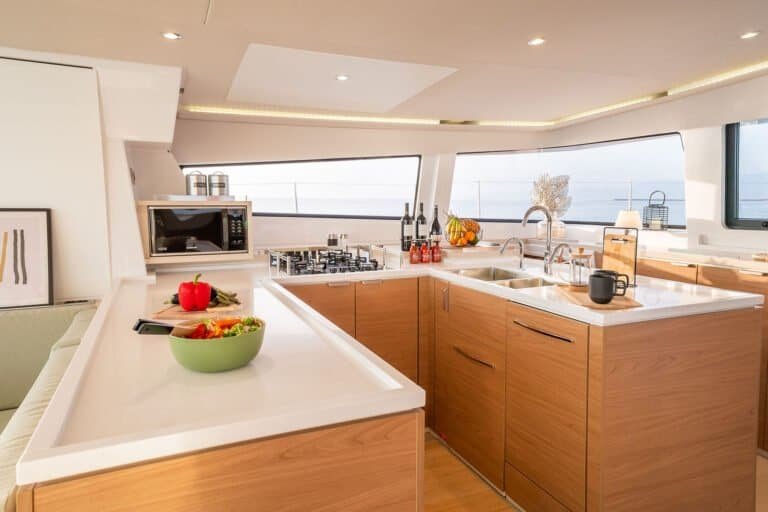 Boat interior with great natural light - fully equipped galley, with microwave, stove, dishwasher, and refrigerator