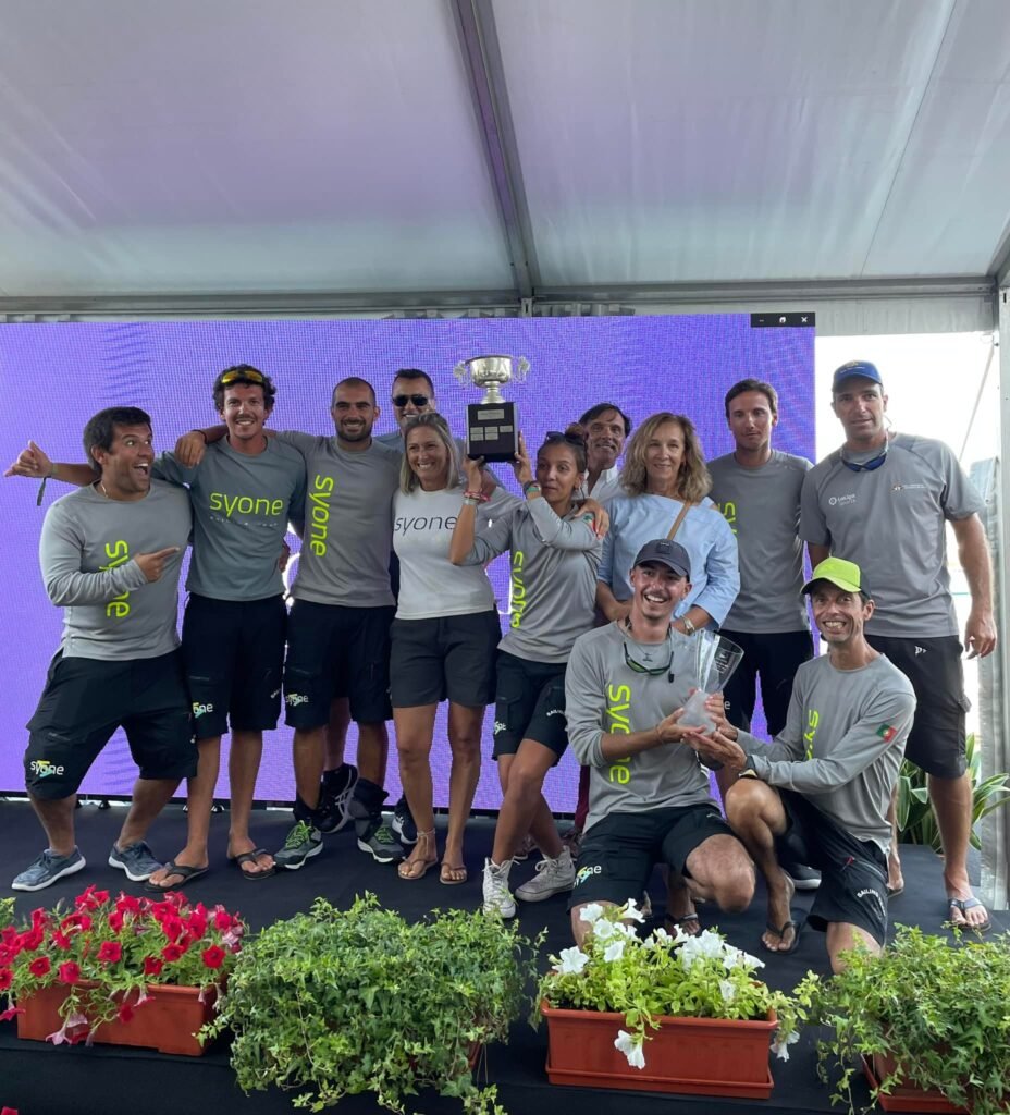 The crew united and satisfied with their performance, in a moment of camaraderie and success in Cascais.