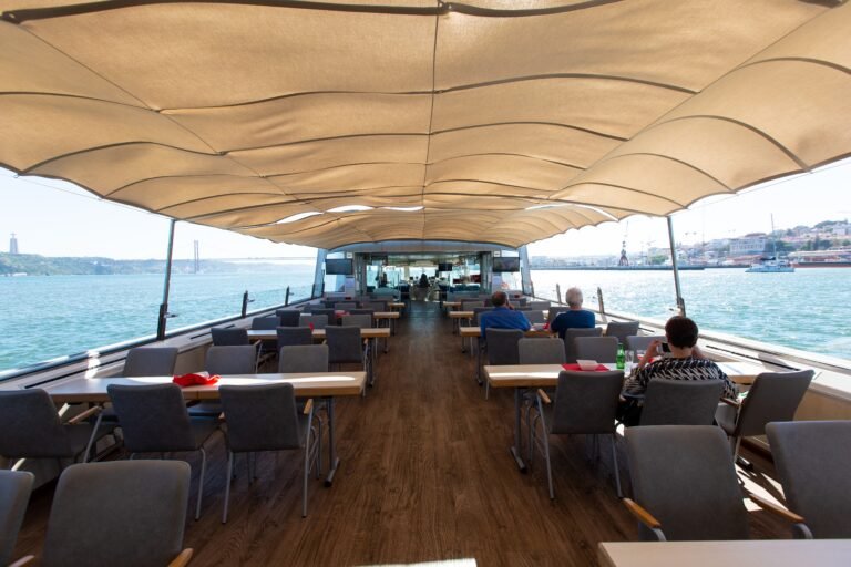 Perspective of the spacious main deck configured for seated dinners (up to 100 people), highlighting the innovative and functional design of the vessel.
