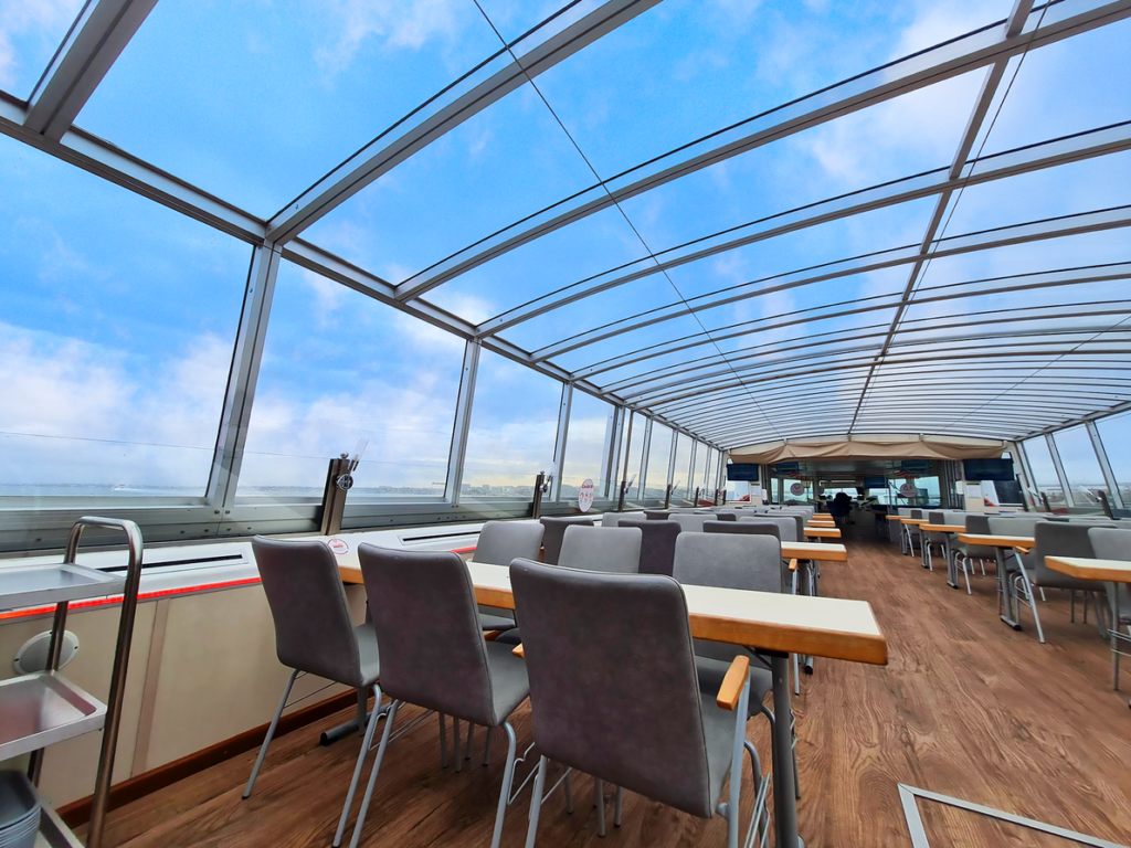A dining area beneath the panoramic roof, offering a bright and comfortable setting for groups seeking stunning views