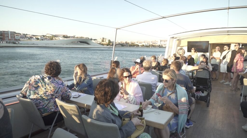 A real-life scene from an event on board, with guests enjoying high-quality table service as they cruise along the Lisbon coastline