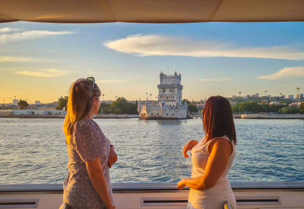 Passengers enjoying the unobstructed view of the Belém Tower directly from the ship